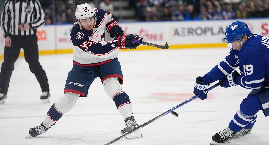 Columbus Blue Jackets defeneseman David Jiricek (55) shoots the puck past Toronto Maple Leafs forward Calle Jarnkrok (19) during the second period at Scotiabank Arena.