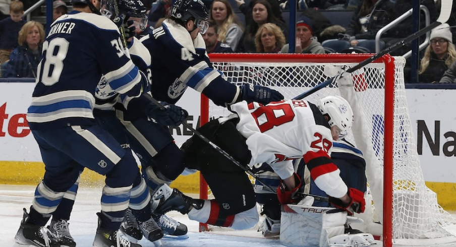 New Jersey Devils' Timo Meier falls onto Columbus Blue Jackets' Elvis Merzlikins during the second period at Nationwide Arena.