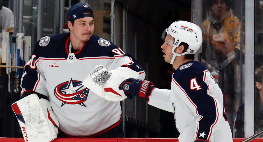 Columbus Blue Jackets goaltender Elvis Merzlikins (90) congratulates center Cole Sillinger (4) on his goal against the Pittsburgh Penguins during the second period at PPG Paints Arena.