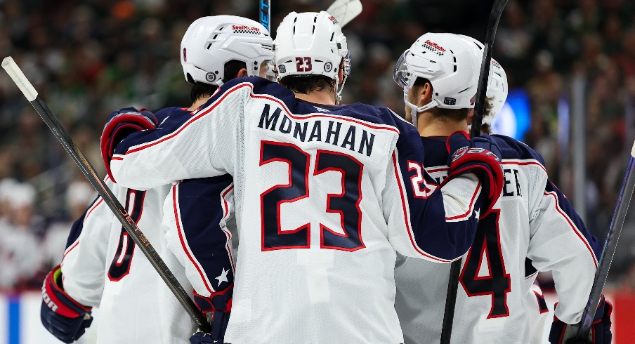 Columbus Blue Jackets defenseman Zach Werenski (8) celebrates his goal with teammates during the third period against the Minnesota Wild at Xcel Energy Center.