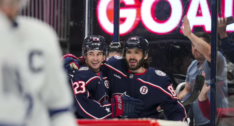 Sean Monahan and Kirill Marchenko celebrate a goal in a 6-2 win over the Toronto Maple Leafs