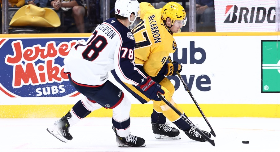 Nashville Predators right wing Michael McCarron (47) passes the puck in front of Columbus Blue Jackets defenseman Damon Severson (78) in the third period at Bridgestone Arena.