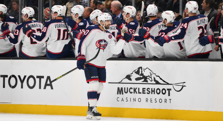 Columbus Blue Jackets center Zachary Aston-Reese (27) celebrates with the bench after scoring a goal against the Seattle Kraken during the first period at Climate Pledge Arena.