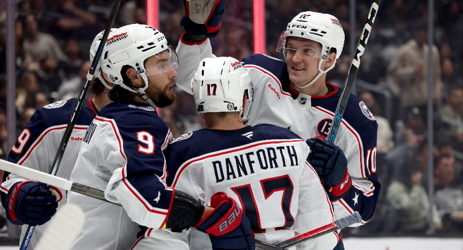 Columbus Blue Jackets defenseman Ivan Provorov (9) celebrates with right wing Justin Danforth (17) and left wing Dmitri Voronkov (10) after scoring during the third period against the Los Angeles Kings at Crypto.com Arena.