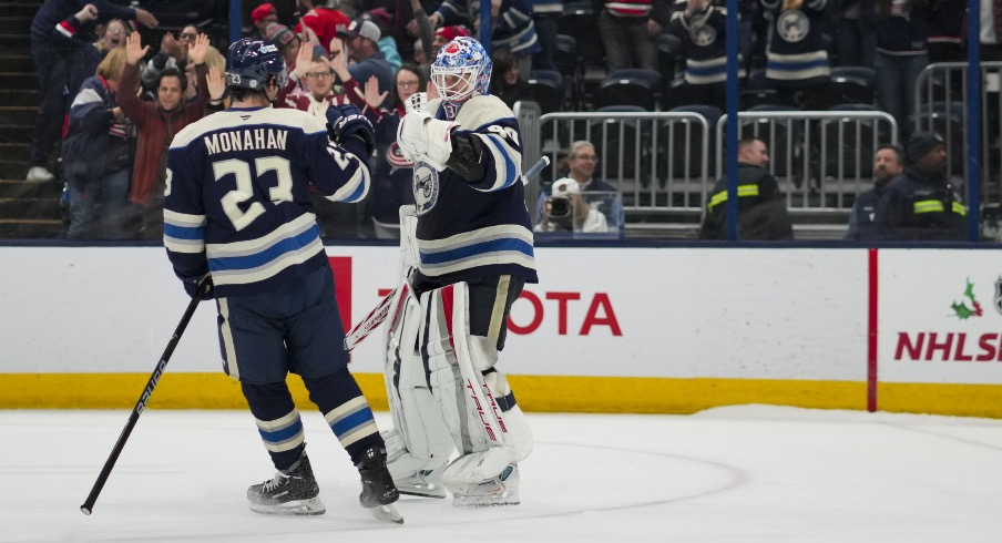 Nov 23, 2024; Columbus, Ohio, USA; Columbus Blue Jackets goaltender Elvis Merzlikins (90) and center Sean Monahan (23) celebrate after defeating the Carolina Hurricanes in a shootout at Nationwide Arena.