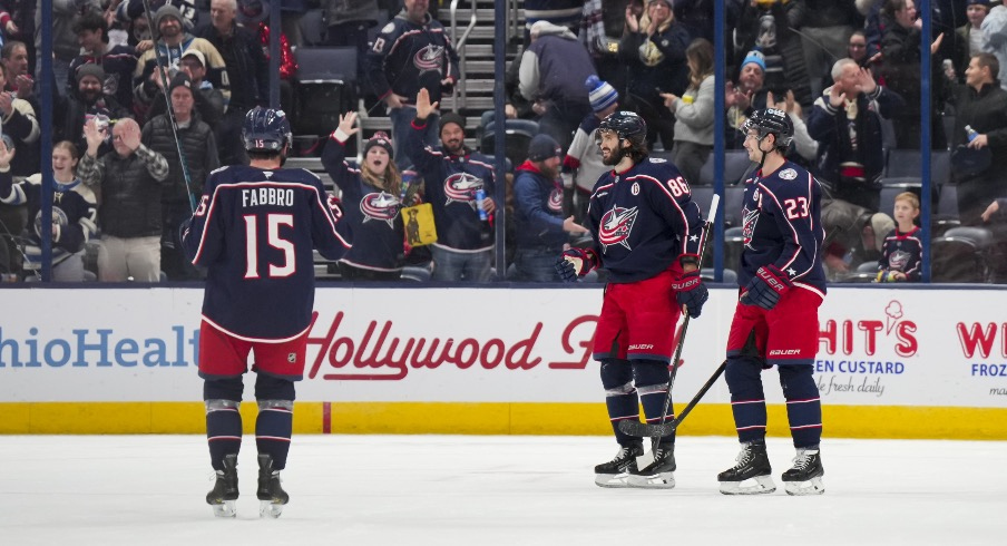 Columbus Blue Jackets right wing Kirill Marchenko (86) celebrates with teammates after scoring an empty net goal against the Calgary Flames in the third period at Nationwide Arena.