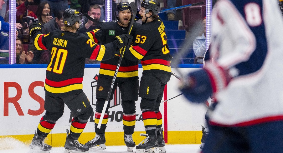 Vancouver Canucks forward Kiefer Sherwood (44) celebrates scoring with forward Danton Heinen (20) and forward Teddy Blueger (53) against the Columbus Blue Jackets during the second period at Rogers Arena.