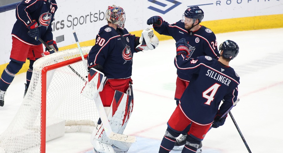 Columbus Blue Jackets goaltender Elvis Merzlikins (90) celebrates with right wing Mathieu Olivier (24) and center Cole Sillinger (4) after defeating the Columbus Blue Jackets at Nationwide Arena.