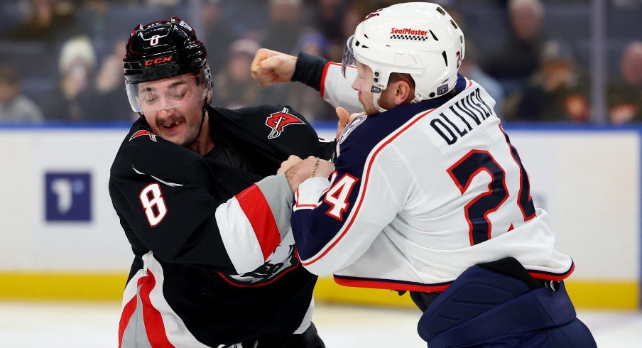 Buffalo Sabres defenseman Dennis Gilbert (8) and Columbus Blue Jackets right wing Mathieu Olivier (24) fight during the first period at KeyBank Center.