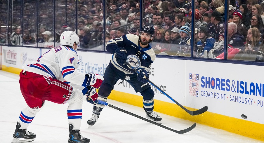 Columbus Blue Jackets center Zachary Aston-Reese (27) passes the puck against New York Rangers defenseman Braden Schneider (4) in the second period at Nationwide Arena on Saturday, Feb. 8, 2025 in Columbus, Ohio.