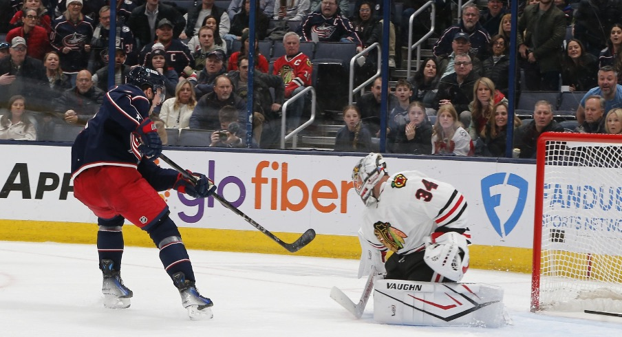 Columbus Blue Jackets defenseman Zach Werenski (8) shot on the breakaway beats Chicago Blackhawks goalie Petr Mrazek (34) for a goal during the third period at Nationwide Arena.