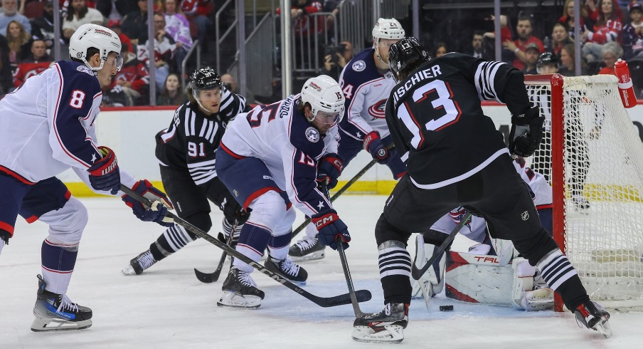 Columbus Blue Jackets goaltender Elvis Merzlikins (90) makes a save on New Jersey Devils center Nico Hischier (13) during the second period at Prudential Center.