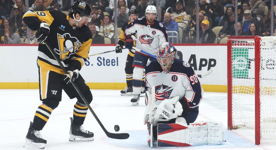 Columbus Blue Jackets goaltender Elvis Merzlikins (90) makes a save against Pittsburgh Penguins center Connor Dewar (19) during the first period at PPG Paints Arena.